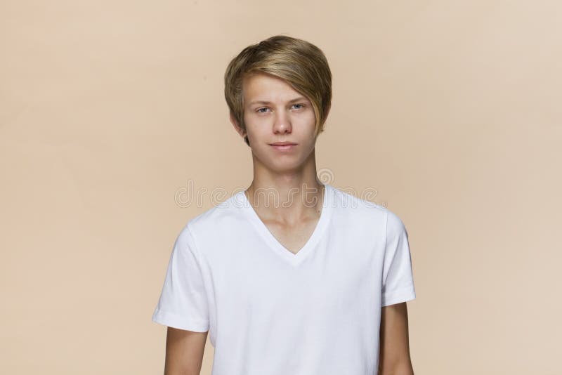 Smiling Positive Male with Attractive Look, Wearing T-shirt, Posing Against Light Brown Blank Wall. Happy Man with Hair Bun Showin Stock Photo - Image of fresh, expression: 126432320 Smiling Positive Male with Attractive Look, Wearing T-shirt, Posing Against Light Brown Blank Wall. Happy Man with Hair Bun Showin Stock Photo - Image of fresh, expression: 126432320