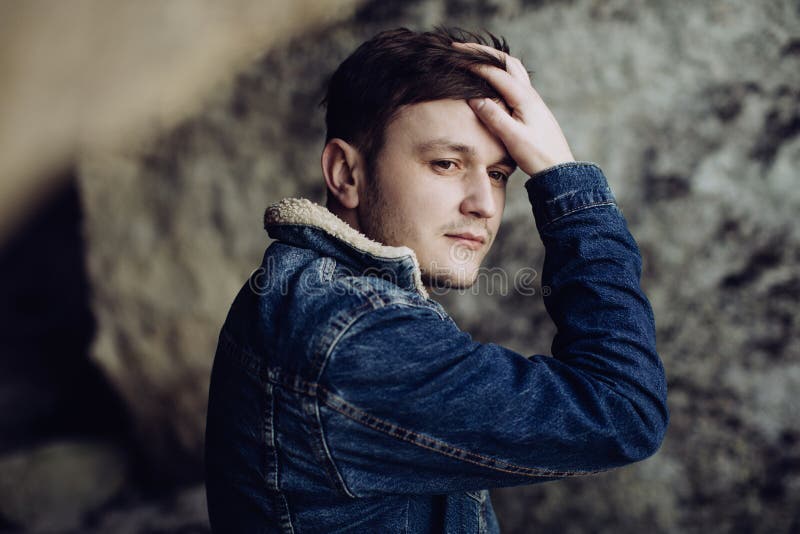 Portrait of a handsome young man in a denim jacket stock photos