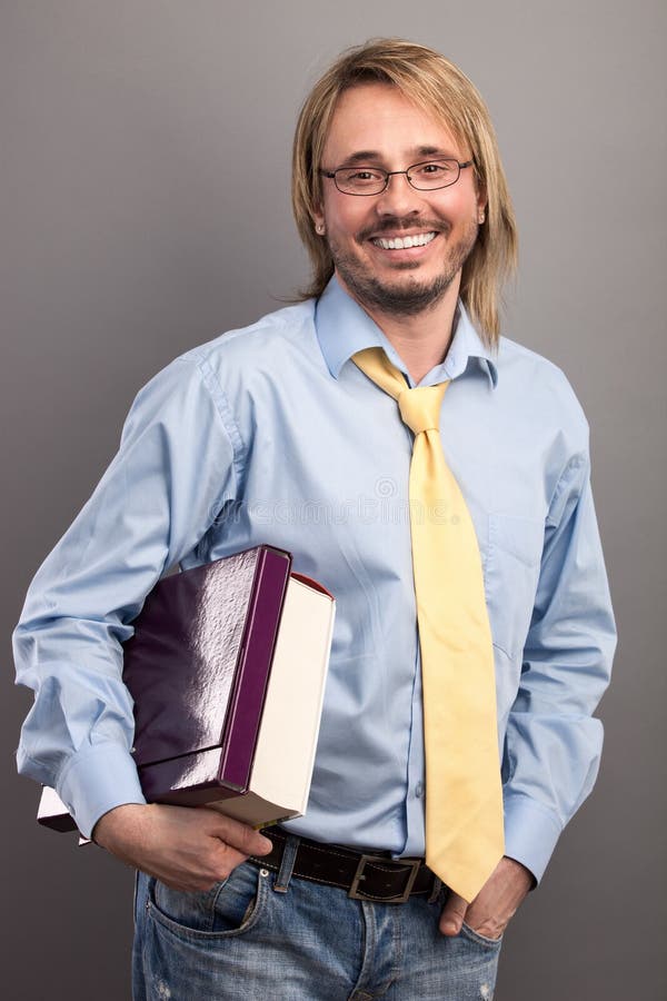 Portrait of handsome young man holding a folder and a book royalty free stock photos Portrait of handsome young man holding a folder and a book royalty free stock photos