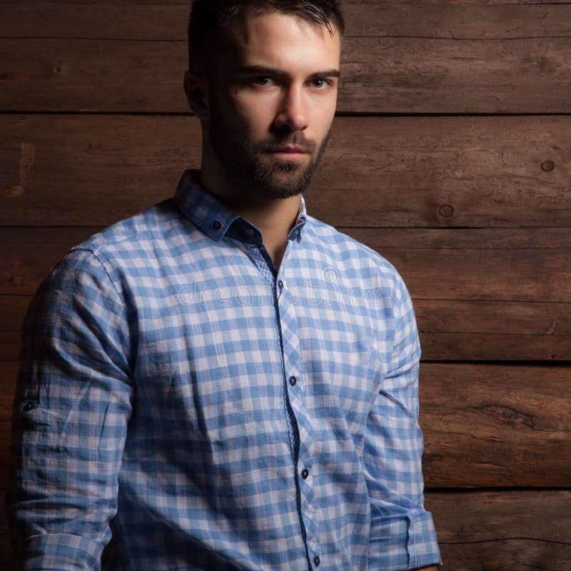 Portrait of handsome young man on wooden background. royalty free stock photography Portrait of handsome young man on wooden background. royalty free stock photography