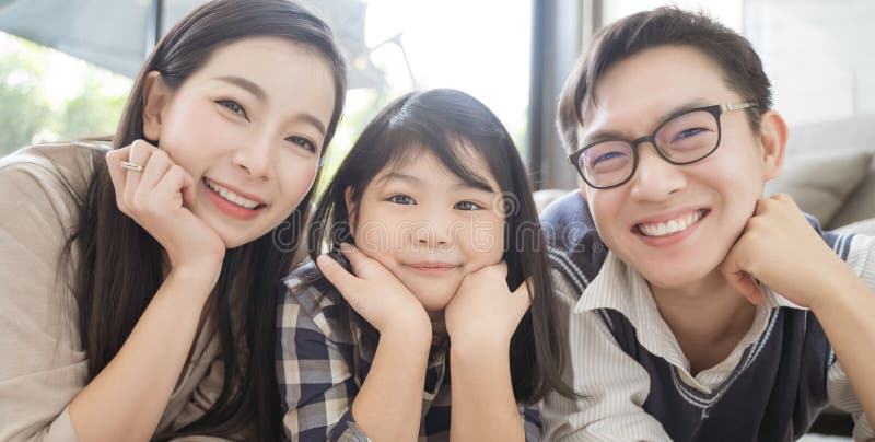 Portrait of happy asian family spending time together in living room. family and home concept. royalty free stock photography Portrait of happy asian family spending time together in living room. family and home concept. royalty free stock photography