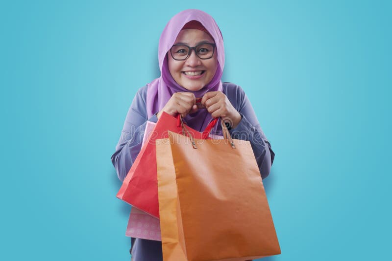 Happy Muslim Woman Bring Shopping Bags royalty free stock photo Happy Muslim Woman Bring Shopping Bags royalty free stock photo