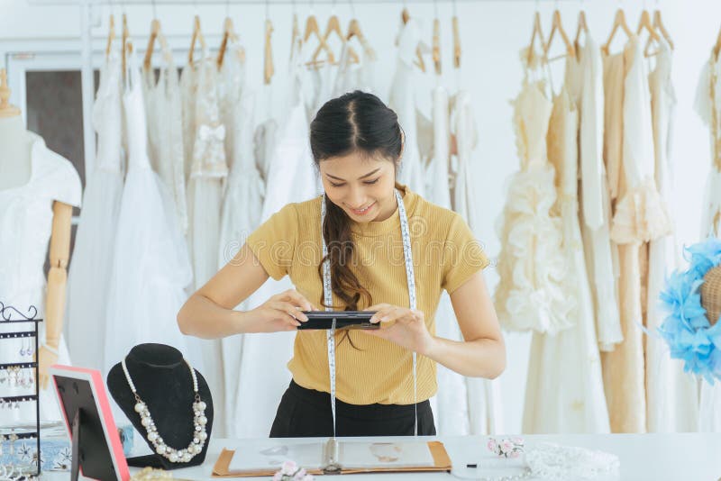 Portrait of happy asian woman wedding dress store owner is working,Beautiful dressmaker in shop and small business