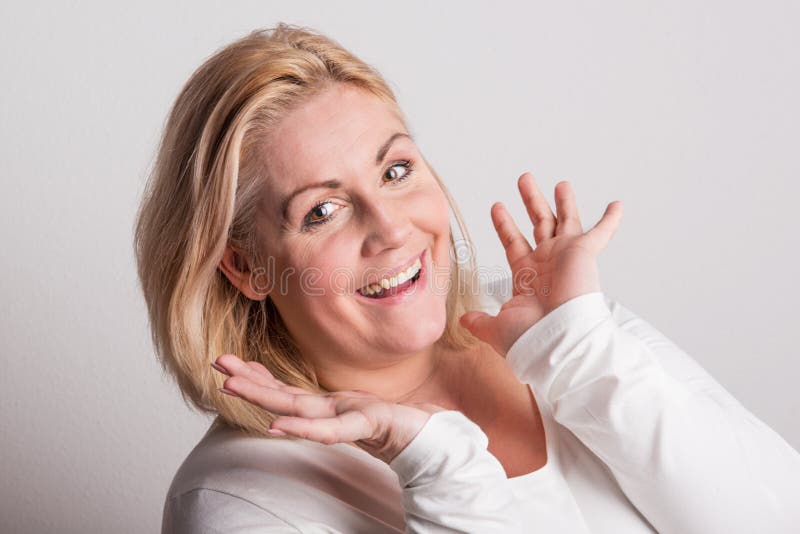 Portrait of an attractive overweight woman in studio on a white background.