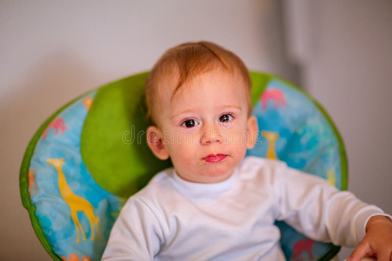 Portrait of happy baby boy in high chair stock image Portrait of happy baby boy in high chair stock image