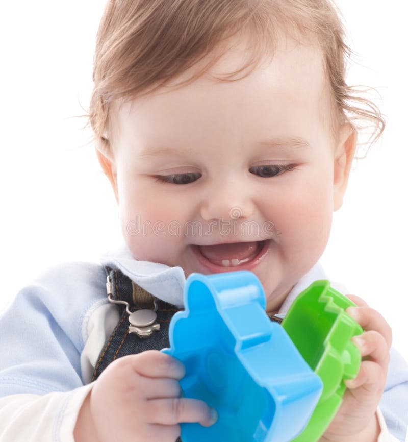 Portrait of happy baby boy playing with toys