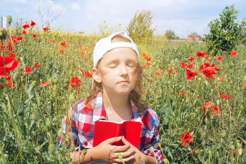 Woman Enjoying Nature . Praying Woman . Child reading book or bible outdoors . Cute little girl reading the Bible . Young Child`s Hands Praying on Holy Bible. Woman Enjoying Nature . Praying Woman . Child reading book or bible outdoors . Cute little girl reading the Bible . Young Child`s Hands Praying on Holy Bible