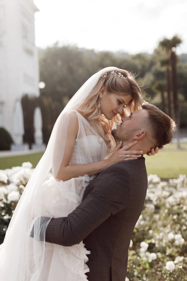 Portrait of a happy bride in luxury dress and groom, wedding love emotions