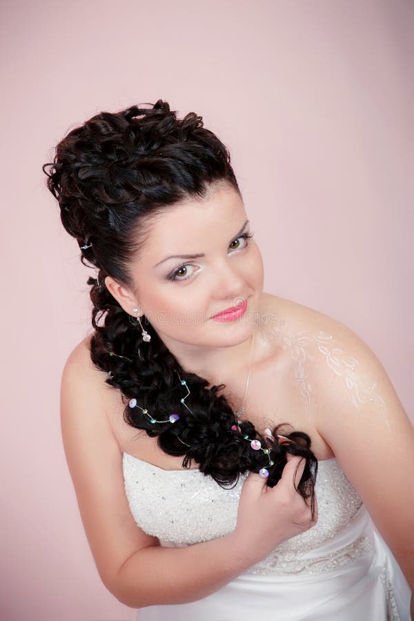 Portrait of a happy bride on a pink background