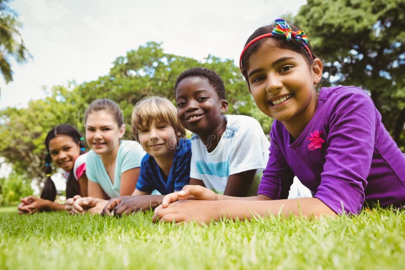 Portrait of happy children lying on grass stock images Portrait of happy children lying on grass stock images