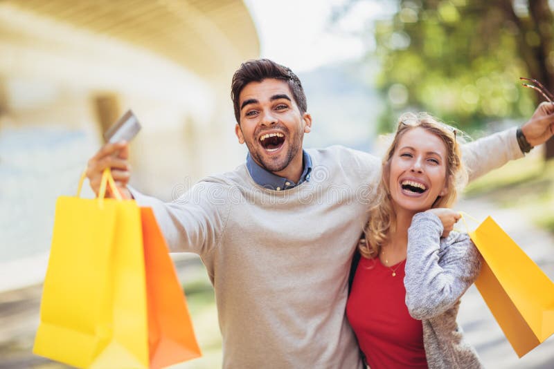 Portrait of happy couple with shopping bags after shopping in ci stock photography Portrait of happy couple with shopping bags after shopping in ci stock photography