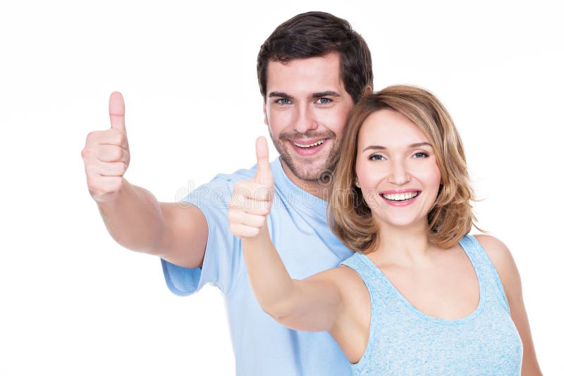 Portrait of happy couple with thumbs up.