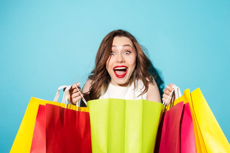 Portrait of a happy excited girl holding colorful shopping bags stock image Portrait of a happy excited girl holding colorful shopping bags stock image