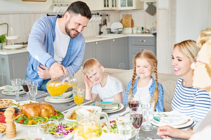 Happy Family at Dinner Table Stock Image - Image of homemade, pouring