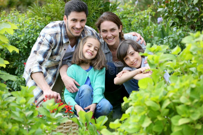 Portrait of Happy Family in the Garden Stock Image - Image of blossom