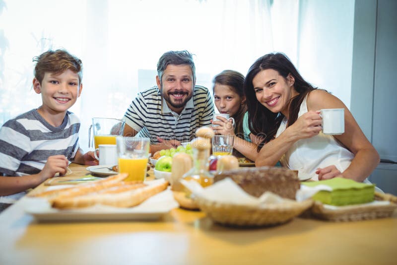 Portrait of happy family having breakfast together