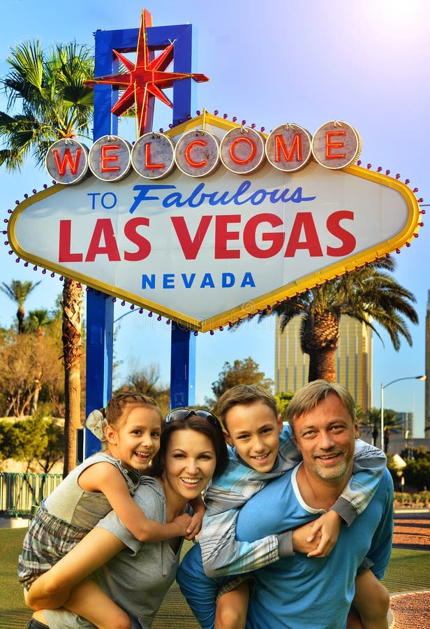 Portrait Of Happy Family Posing Against Las Vegas Sign Stock Image