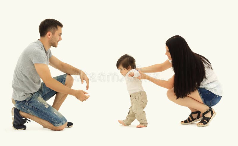 Portrait of a happy family that teaches a child to walk