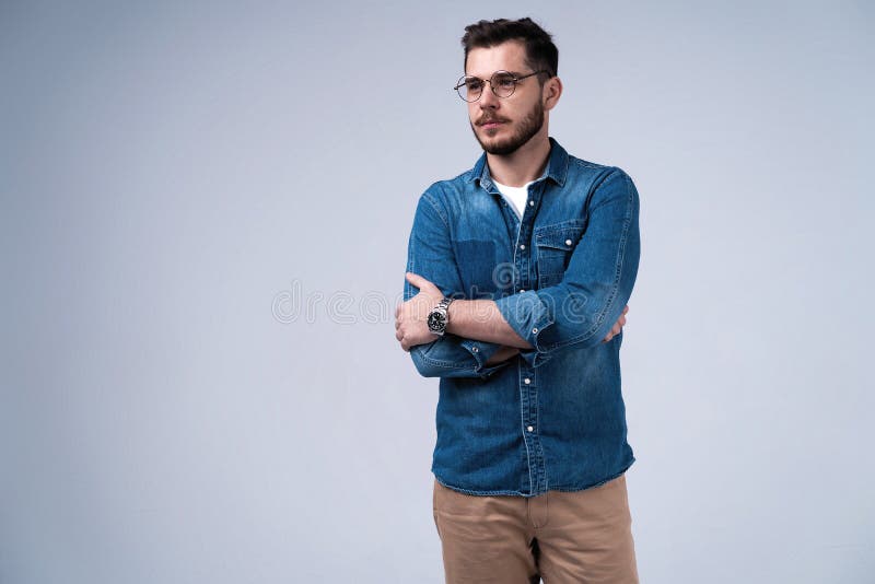 Portrait of happy fashionable handsome man in jeans shirt crossing hands and look at camera. stock photography Portrait of happy fashionable handsome man in jeans shirt crossing hands and look at camera. stock photography