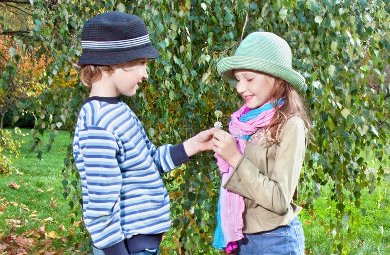 Portrait of happy girl and boy enjoying golden autumn season