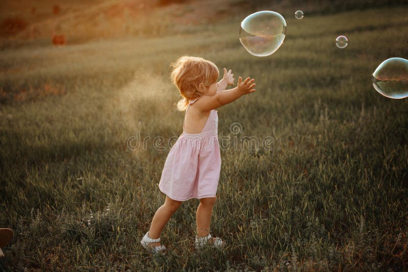 Portrait of Happy Joyful Child in Pink Dress Over Wild Yellow Field ...