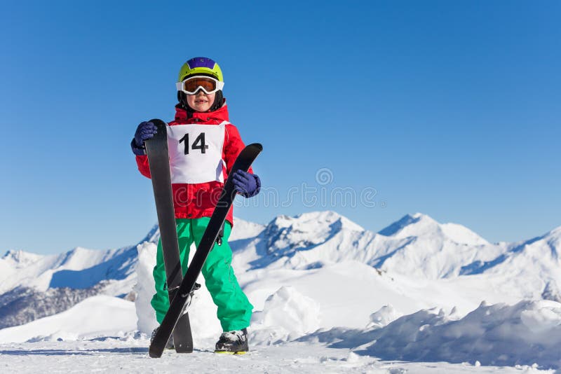 Portrait of happy kid boy holding skis in his hand stock photo Portrait of happy kid boy holding skis in his hand stock photo
