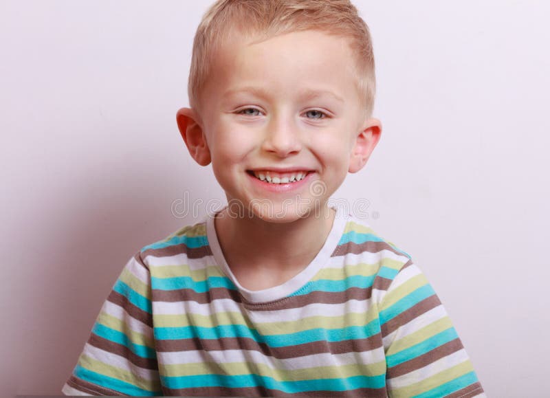 Portrait of happy laughing blond boy child kid at the table royalty free stock images Portrait of happy laughing blond boy child kid at the table royalty free stock images