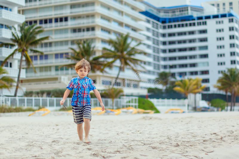 Portrait of happy little kid boy on the beach of ocean. Funny cute child making vacations and enjoying summer. Healthy stock photography Portrait of happy little kid boy on the beach of ocean. Funny cute child making vacations and enjoying summer. Healthy stock photography
