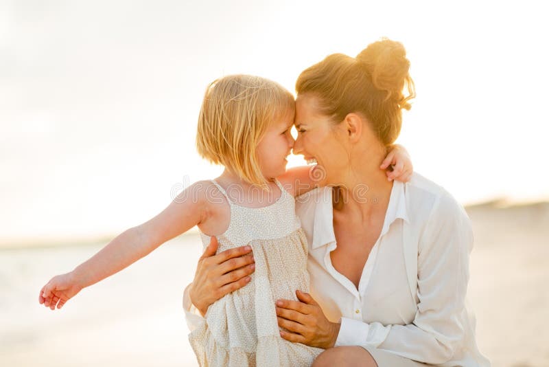 Portrait of happy mother and baby girl hugging