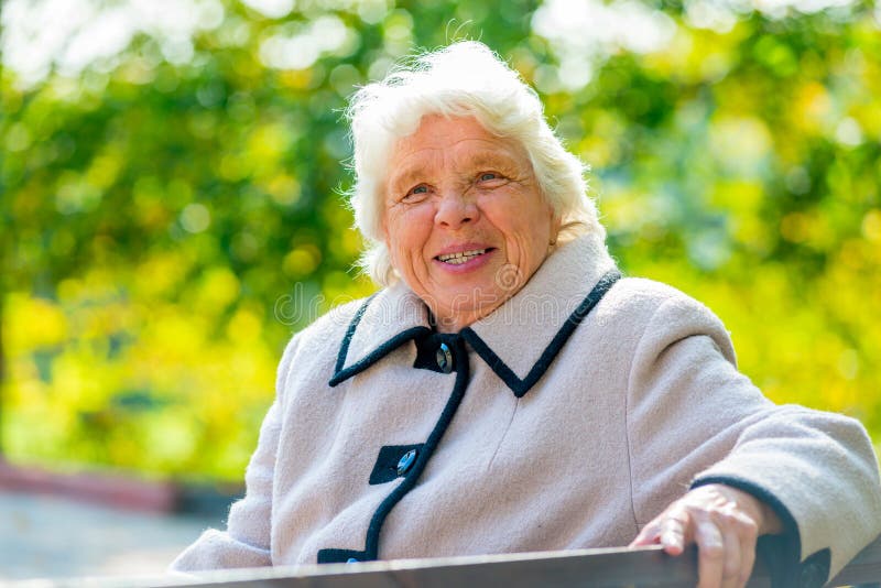Portrait of happy pensioner sitting on a bench royalty free stock photography Portrait of happy pensioner sitting on a bench royalty free stock photography
