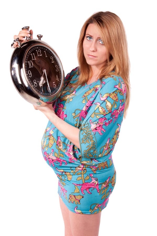 Portrait of happy pregnant woman with clock