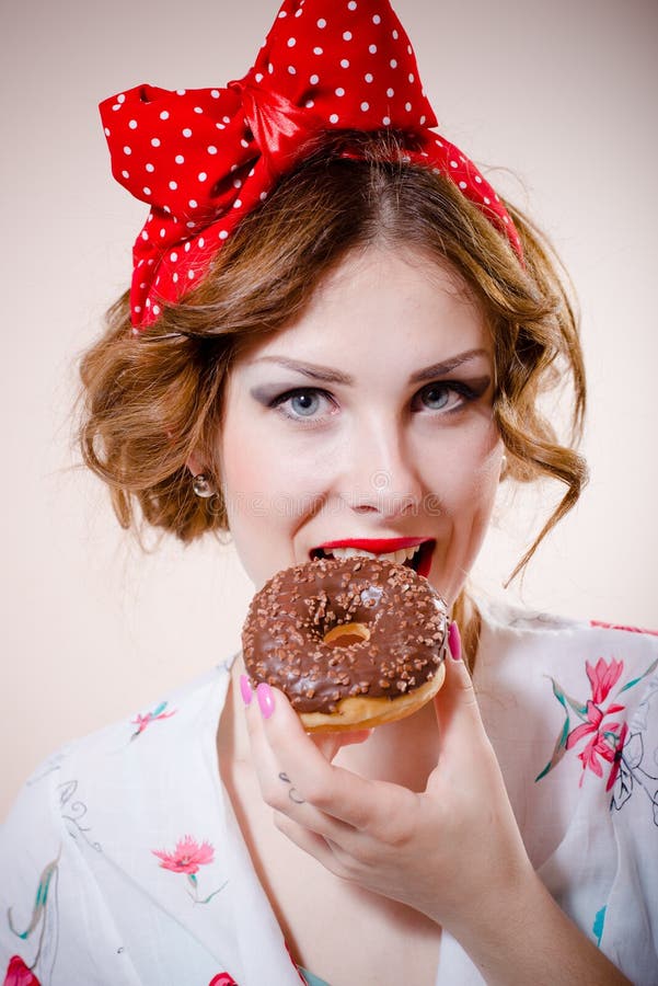 Portrait of happy pretty girl beautiful blond young woman with excellent dental care teeth having fun eating donut