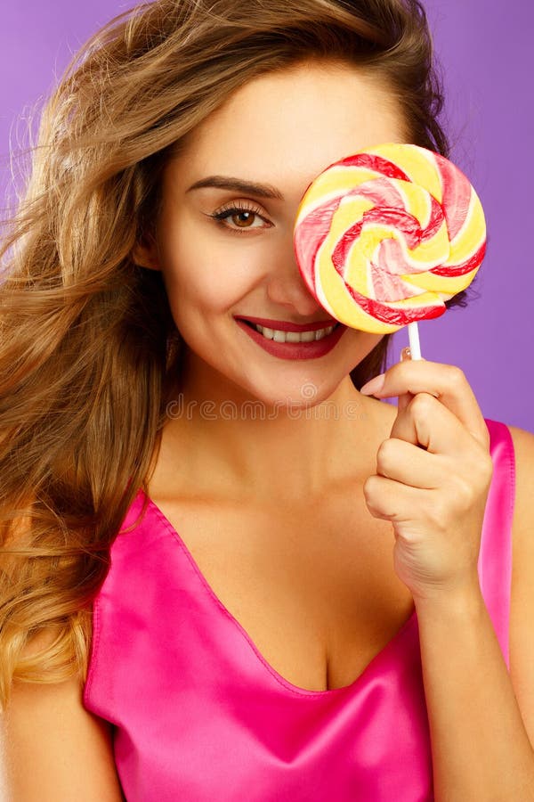 Portrait Of A Happy Pretty Girl Holding Sweet Candy Over Violet Stock Image Image Of Beautiful