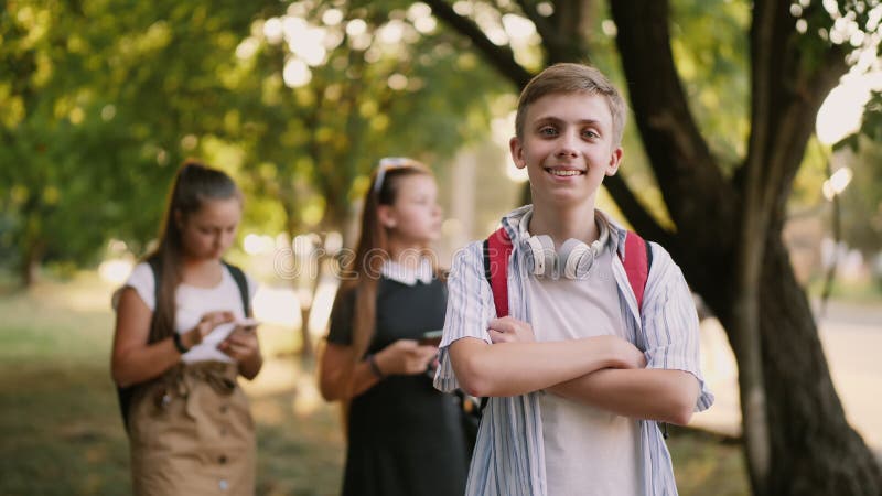 Portrait of a happy schoolboy on the street