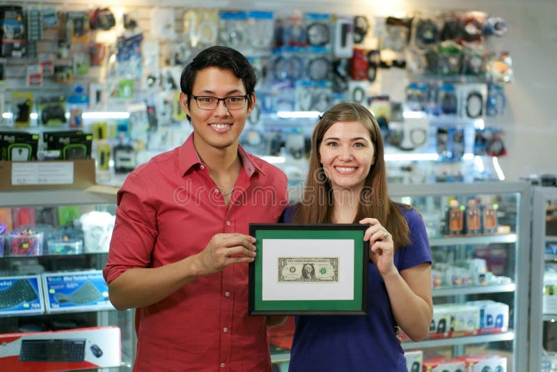 Portrait Of Happy Shop Owners Showing First Dollar Earning royalty free stock images Portrait Of Happy Shop Owners Showing First Dollar Earning royalty free stock images