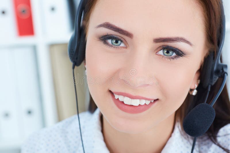 Portrait of happy smiling female customer support phone operator with headset on head at workplace. stock photos Portrait of happy smiling female customer support phone operator with headset on head at workplace. stock photos