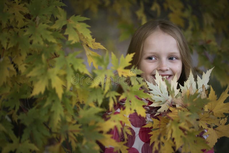 Portrait of a Happy smiling little girl in the autumn park. Cute four years old child enjoying nature outdoors. stock images Portrait of a Happy smiling little girl in the autumn park. Cute four years old child enjoying nature outdoors. stock images