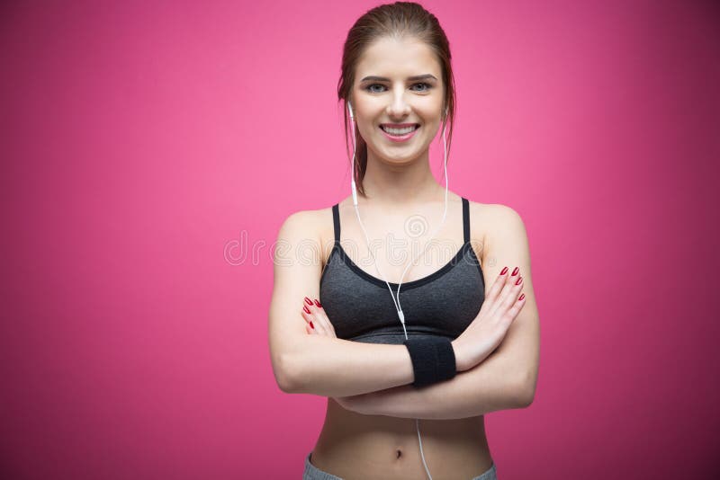 https://thumbs.dreamstime.com/b/portrait-happy-sports-woman-standing-arms-folded-over-pink-background-49983176.jpg