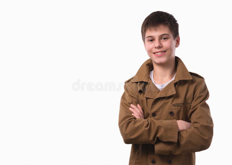 Portrait of happy teen boy with folded hands on white background.