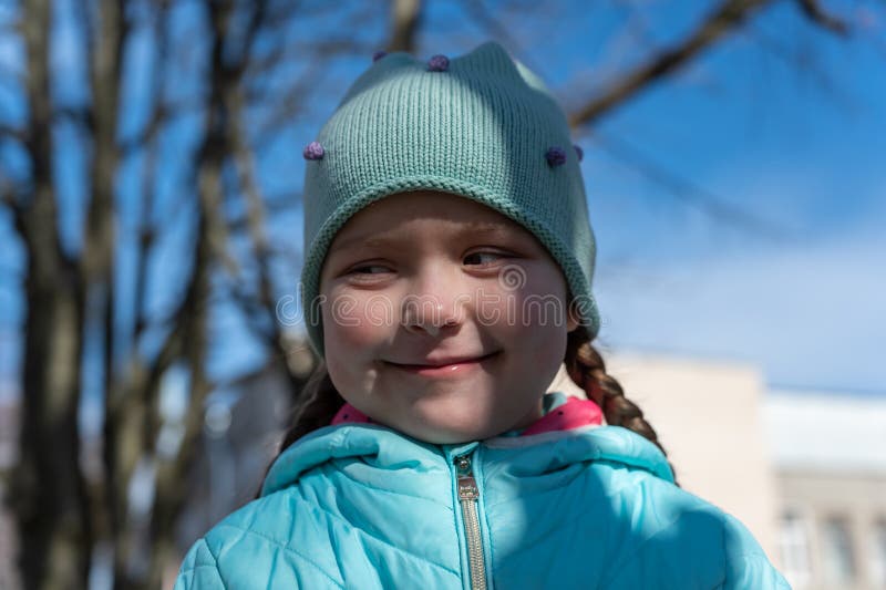A Portrait of a Happy Ukrainian Girl Against the Blue Sky and Trees. a ...
