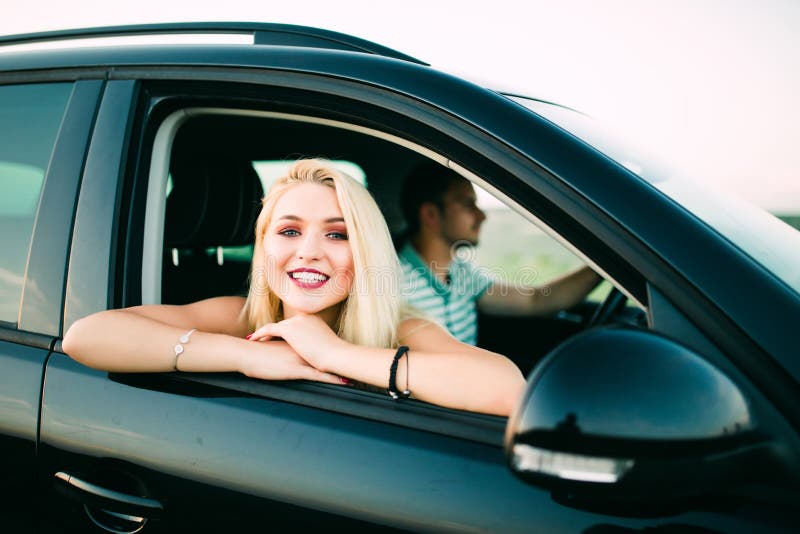Portrait of Happy Young Woman Going on a Road Trip Leaning Out of ...
