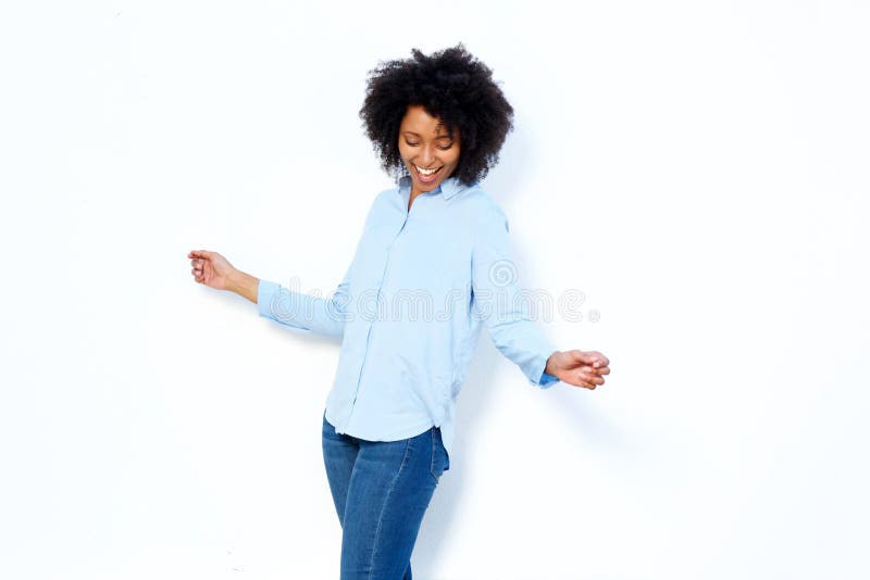 Happy young african woman dancing and enjoying against white background royalty free stock image
