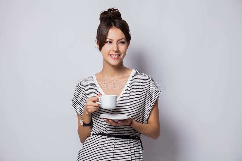 Portrait of a happy young business woman holding cup of coffee isolated over white background. stock photography Portrait of a happy young business woman holding cup of coffee isolated over white background. stock photography