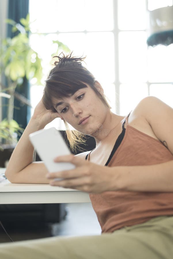 Portrait of happy young businesswoman using mobile phone in offi royalty free stock photo Portrait of happy young businesswoman using mobile phone in offi royalty free stock photo