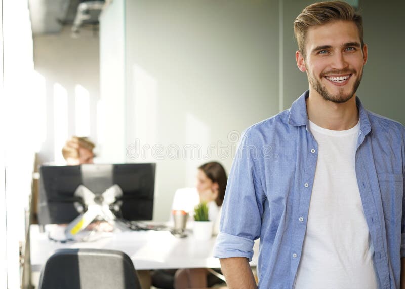 Portrait of a Happy Young Casual Businessman at Office, Smiling. Stock ...