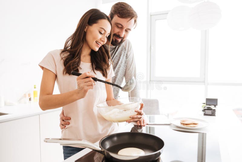 Portrait of a Happy Young Couple Cooking Pancakes Stock Photo - Image ...