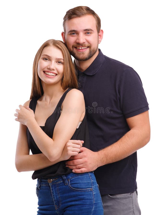 Premium Photo  A young man hugs a girl by the waist couple standing with  their backs to the camera