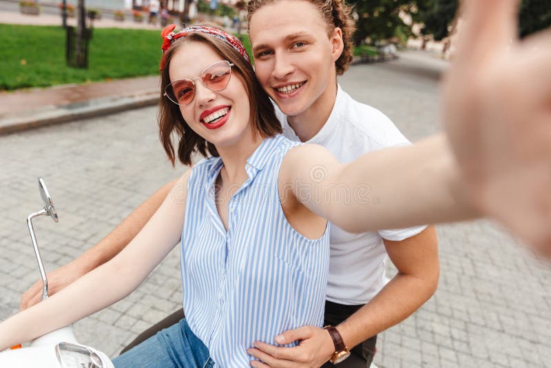 Portrait of a Happy Young Couple Riding on a Motorbike Stock Image