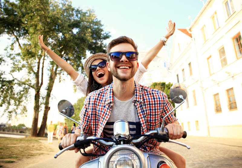Portrait of happy young couple on scooter enjoying road trip royalty free stock image Portrait of happy young couple on scooter enjoying road trip royalty free stock image
