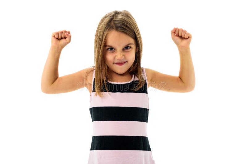 Portrait of happy young little girl showing and flexing muscles. Portrait of active little child girl flexing her arms - showing muscle. Concept of independent woman and gender equality.